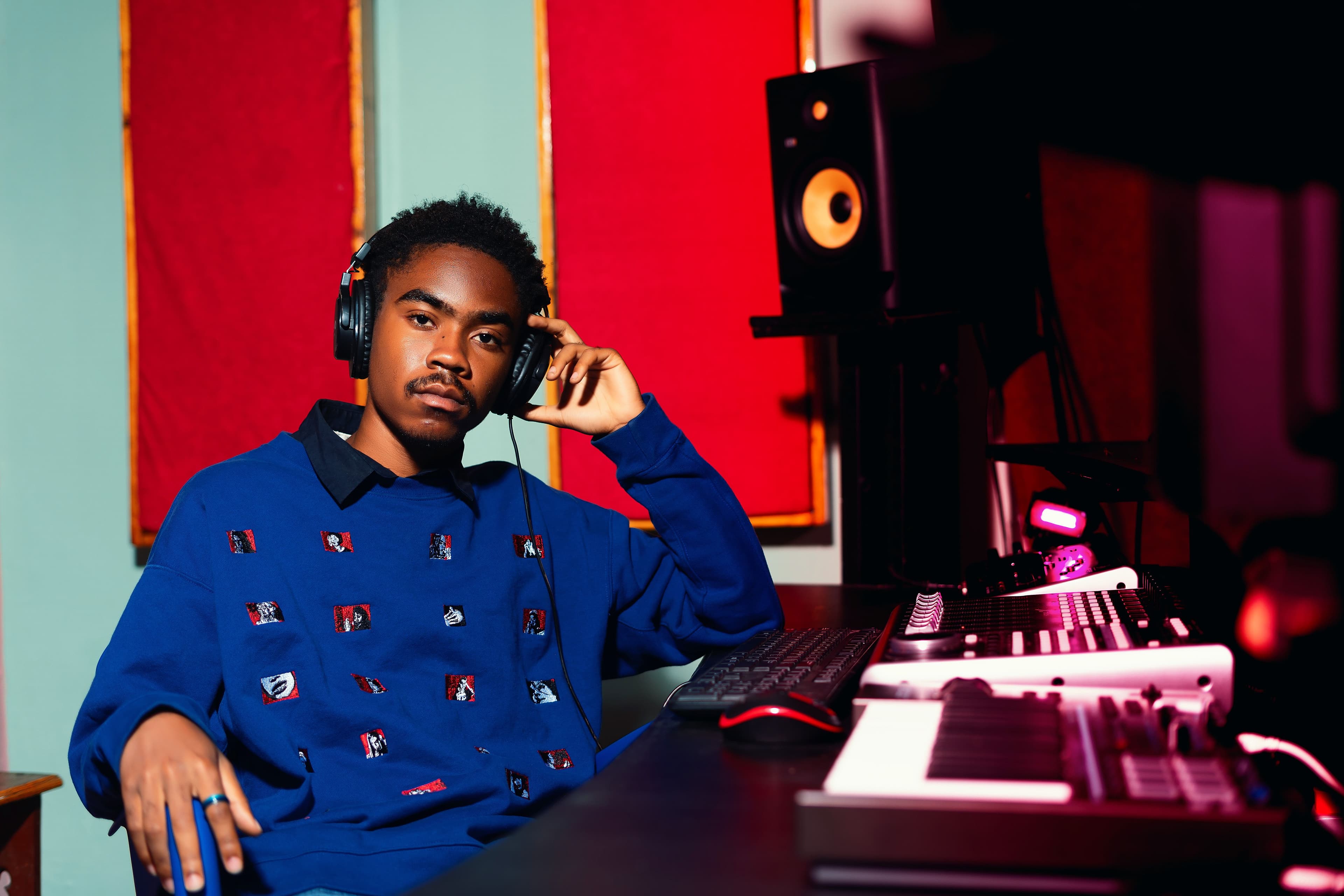 Music producer wearing headphones in a recording studio